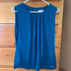 Blue pleated sleeveless blouse